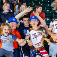 Photo of a family with Detroit Tigers jerseys cheering in the audience pt. 2